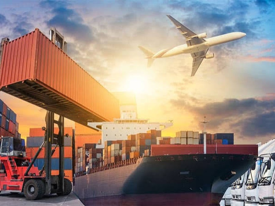 Multi-modal freight showing a cargo ship, aircraft and trucks